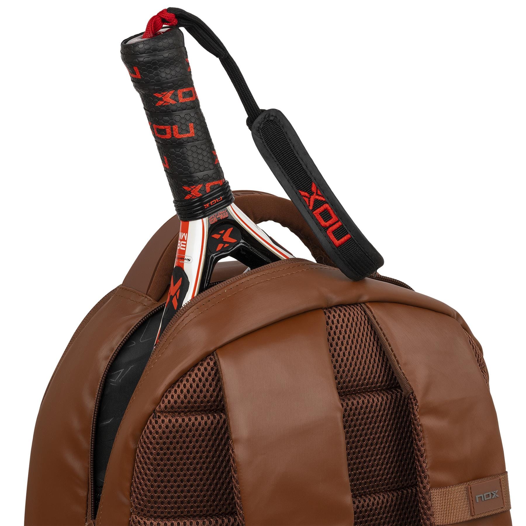 The NOX Pro Series Padel Backpack - Camel, with mesh straps and air ventilation, securely holds your padel racket—its handle wrapped in black and red NOX grip tape—making it ideal for carrying all your padel essentials.