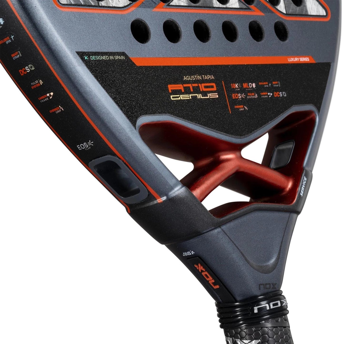 Close-up of the NOX AT10 Luxury Genius 18K Alum By Agustin Tapia 2025 Padel Racket, showing black, red, and orange accents, textured grip, NOX branding, and "18K Carbon Alum" specs printed on the paddle's surface.