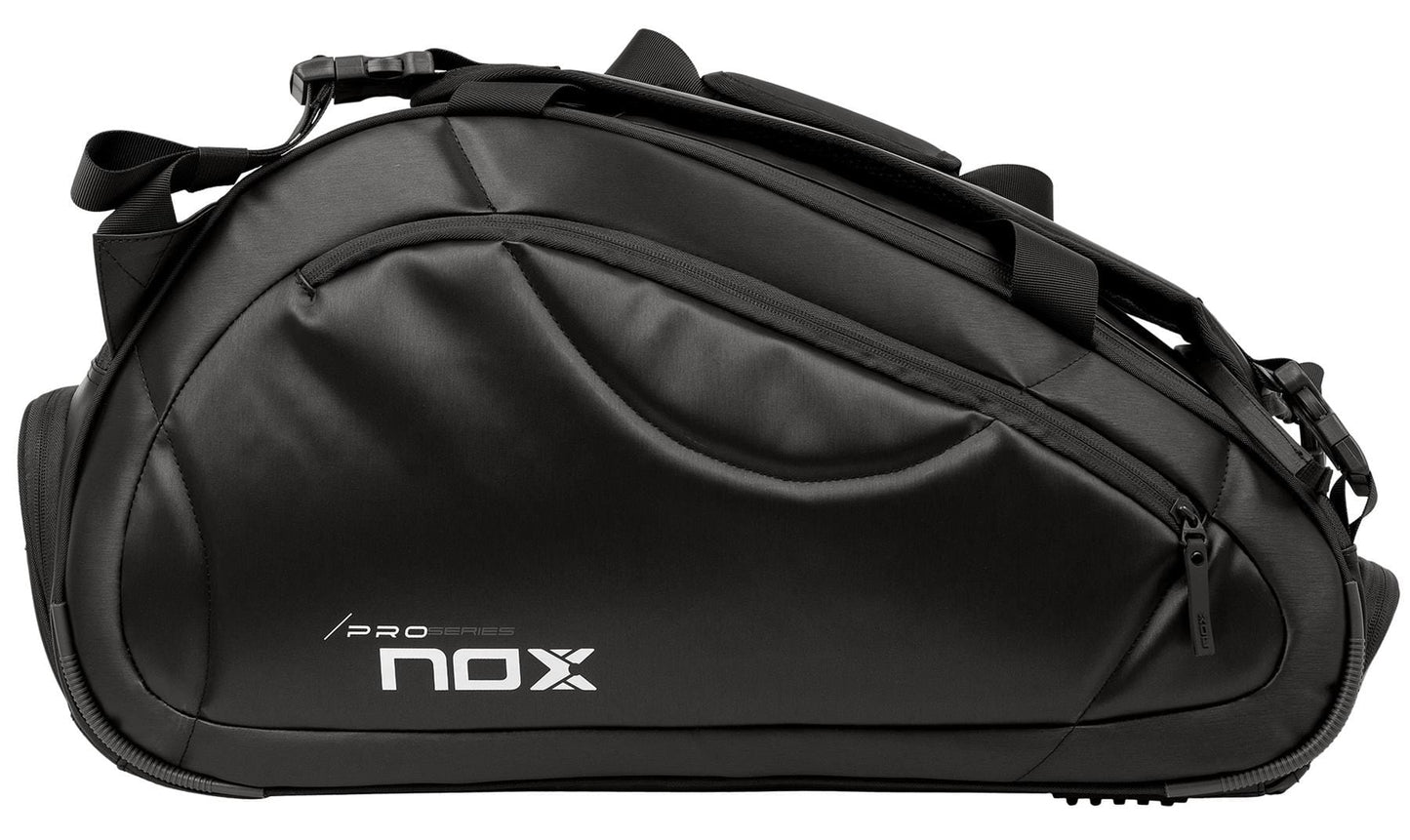 The NOX Pro Series Padel Racket Bag - Black features a sleek design, side zipper pocket, “Pro Series” and “NOX” print, multiple straps, padded panels, and ample storage for your gear.