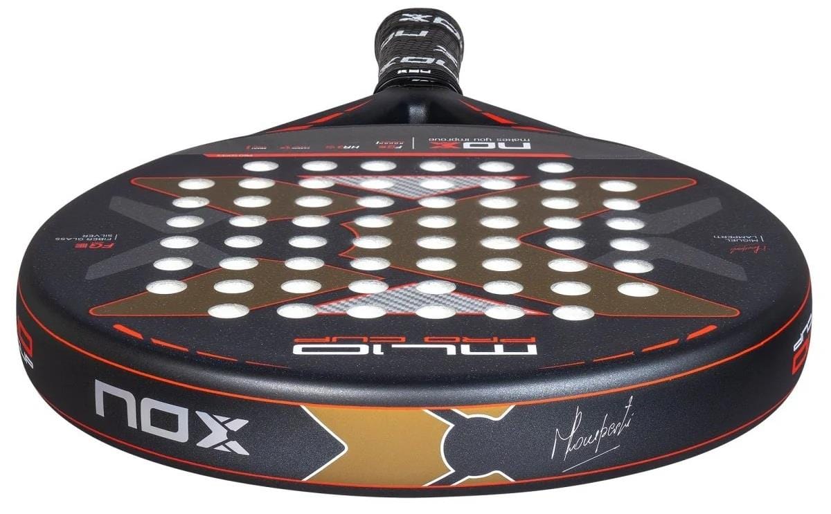 The NOX ML10 Pro Cup Rough Surface By Miguel Lamperti 2025 Padel Racket features a black and red design with white holes, a large "X," black grip tape, the Smartstrap® System for safety, and bold "NOX" branding on its rough surface.