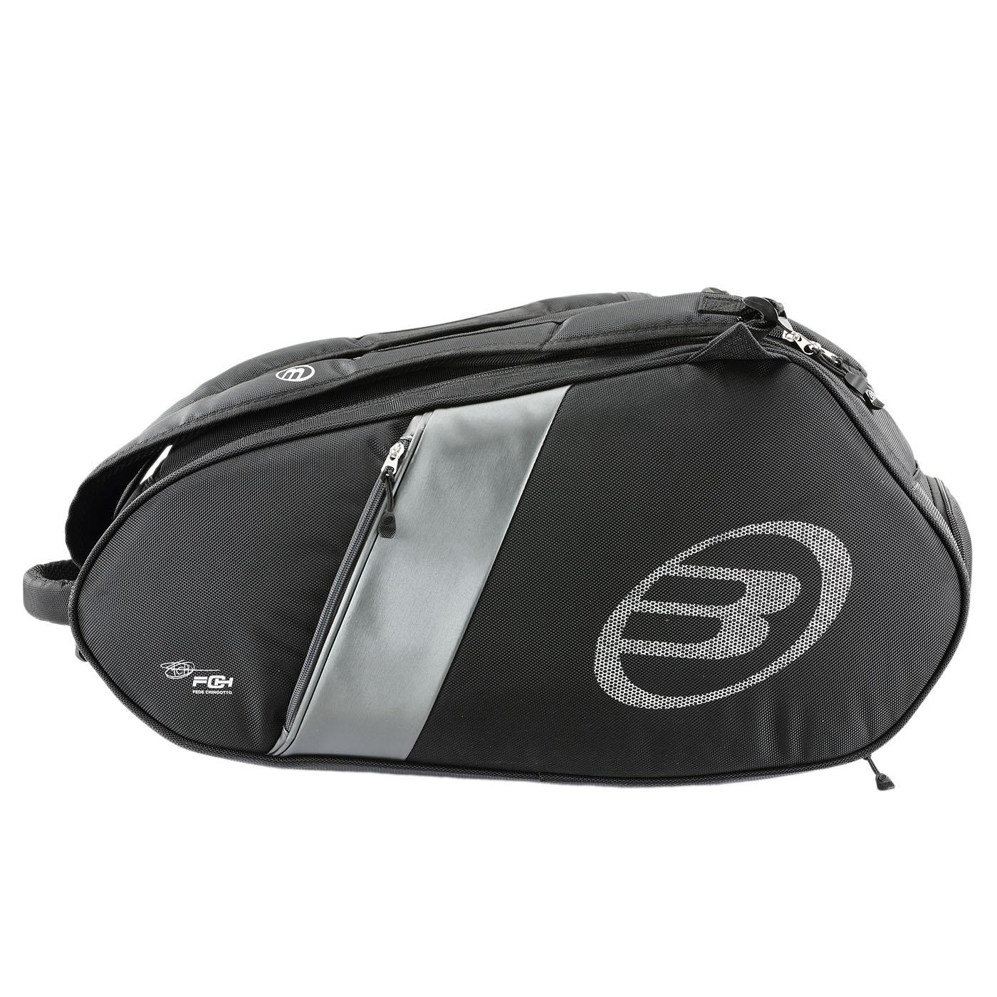 The Bullpadel Neuron 25 Padel Racket Bag in black is ideal for padel rackets. It features a zippered main compartment, an extra small pocket, a circular side logo, and a shoulder strap for easy transport of gear like the Bullpadel Neuron 25 or Flow Padel Racket.