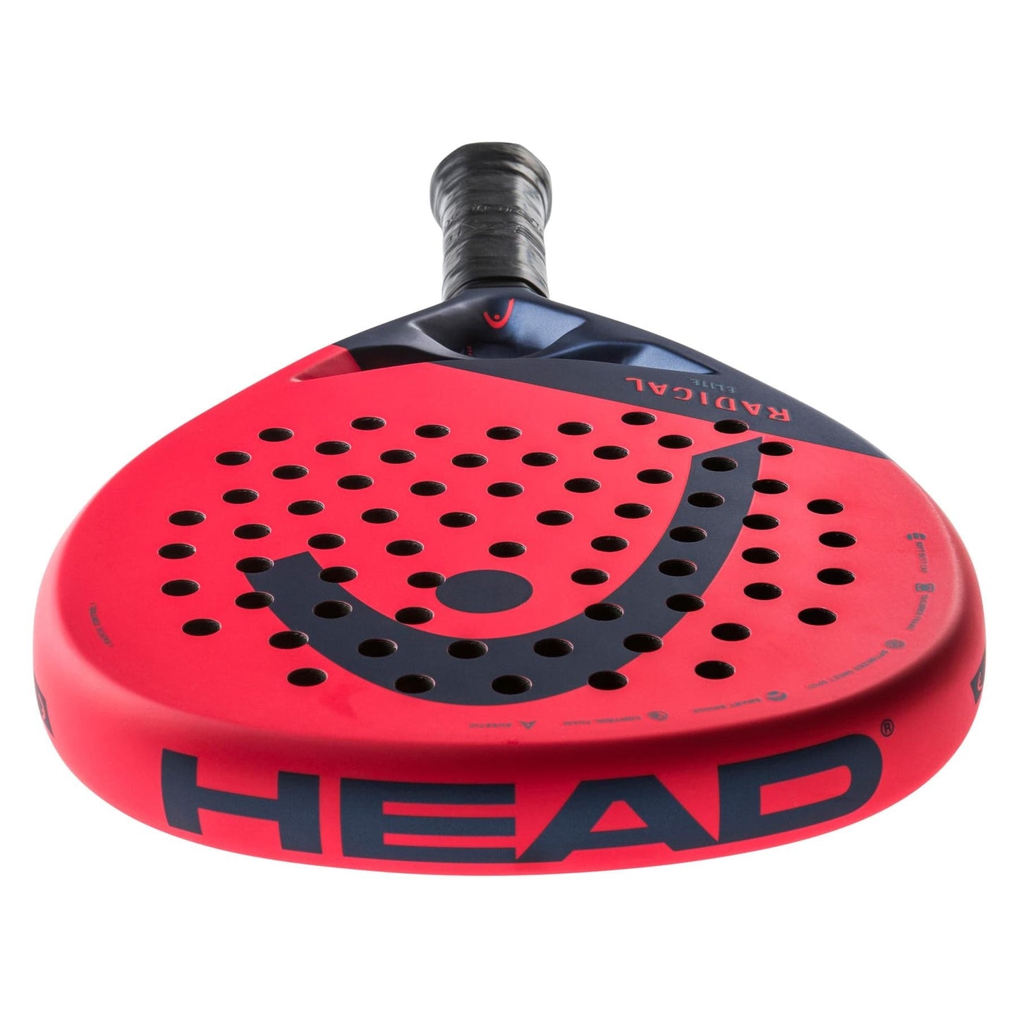 An orange padel racket, viewed from a low angle, highlights auxetic technology for improved performance. The HEAD Radical Elite 2024 design features perforations on the face and prominently displays the brand logo. The handle is black with a ribbed grip and has "HEAD" boldly printed on the edge, catering to control game enthusiasts.