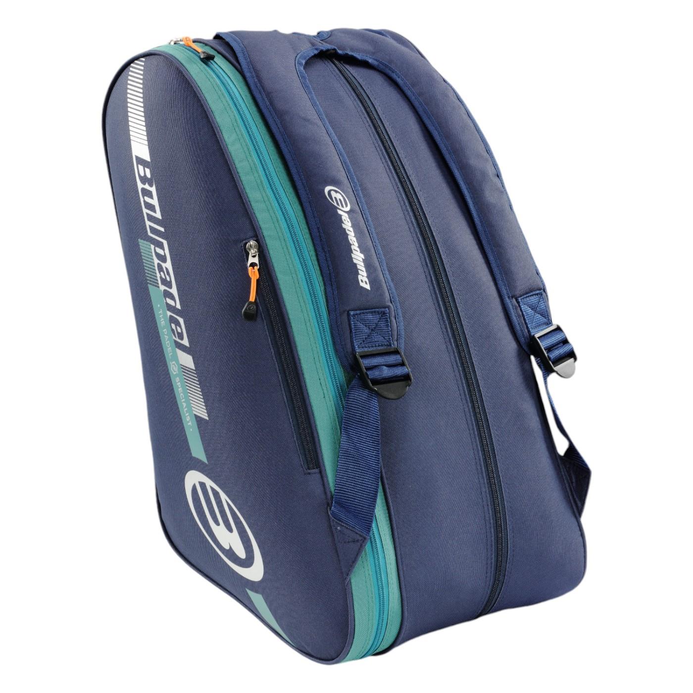 The Bullpadel Tour 25 Padel Racket Bag in navy boasts prominent Bullpadel branding with orange and teal graphics. It includes multiple compartments, a padded racket section, adjustable straps, and a padded handle for comfortable carrying.