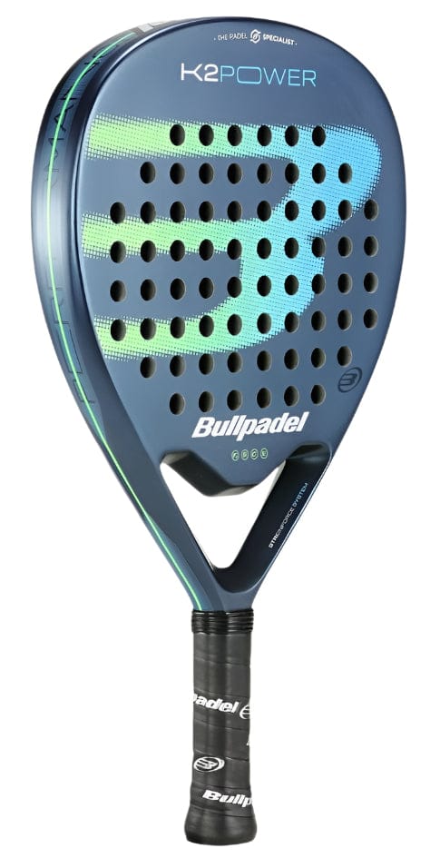 The Bullpadel K2 Power 2025 Padel Racket in blue boasts a perforated surface and a CarbonTube frame for durability. Its handle has black grip tape, and the Bullpadel brand name is displayed on the face, marking it as high-performance.