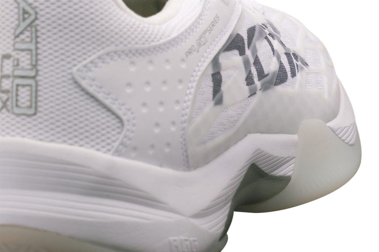 Close-up of the NOX AT10 Lux Men's Padel Shoes in White/Grey, designed for Agustin Tapia. These premium shoes from NOX feature textured details, mesh panels, a thick curved sole with translucent rubber, and a black logo on the side.