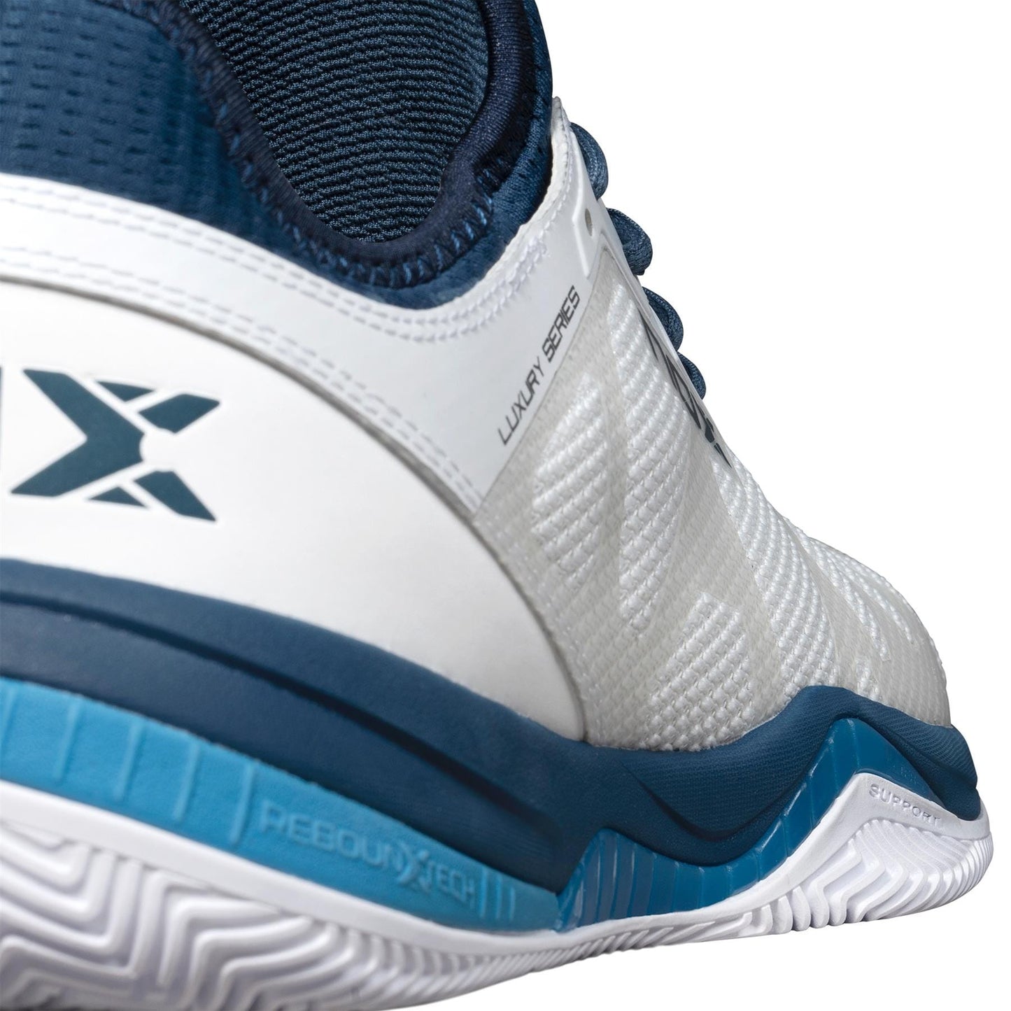 Close-up of the NOX Nerbo Mens Padel Shoes in White/Swedish Blue, featuring textured material, a blue and white sole, "LUXURY SERIES" detail, a stylized "X" logo, and advanced technology for comfort and performance.