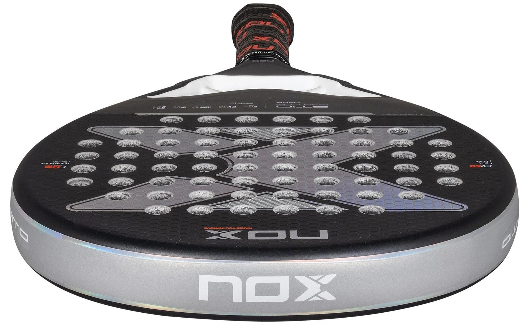 A close-up of the black NOX AT10 Pro Cup HARD By Agustin Tapia 2025 padel racket, featuring a silver edge, X-pattern holes, and a red-black grip handle with Smartstrap® system for safety.
