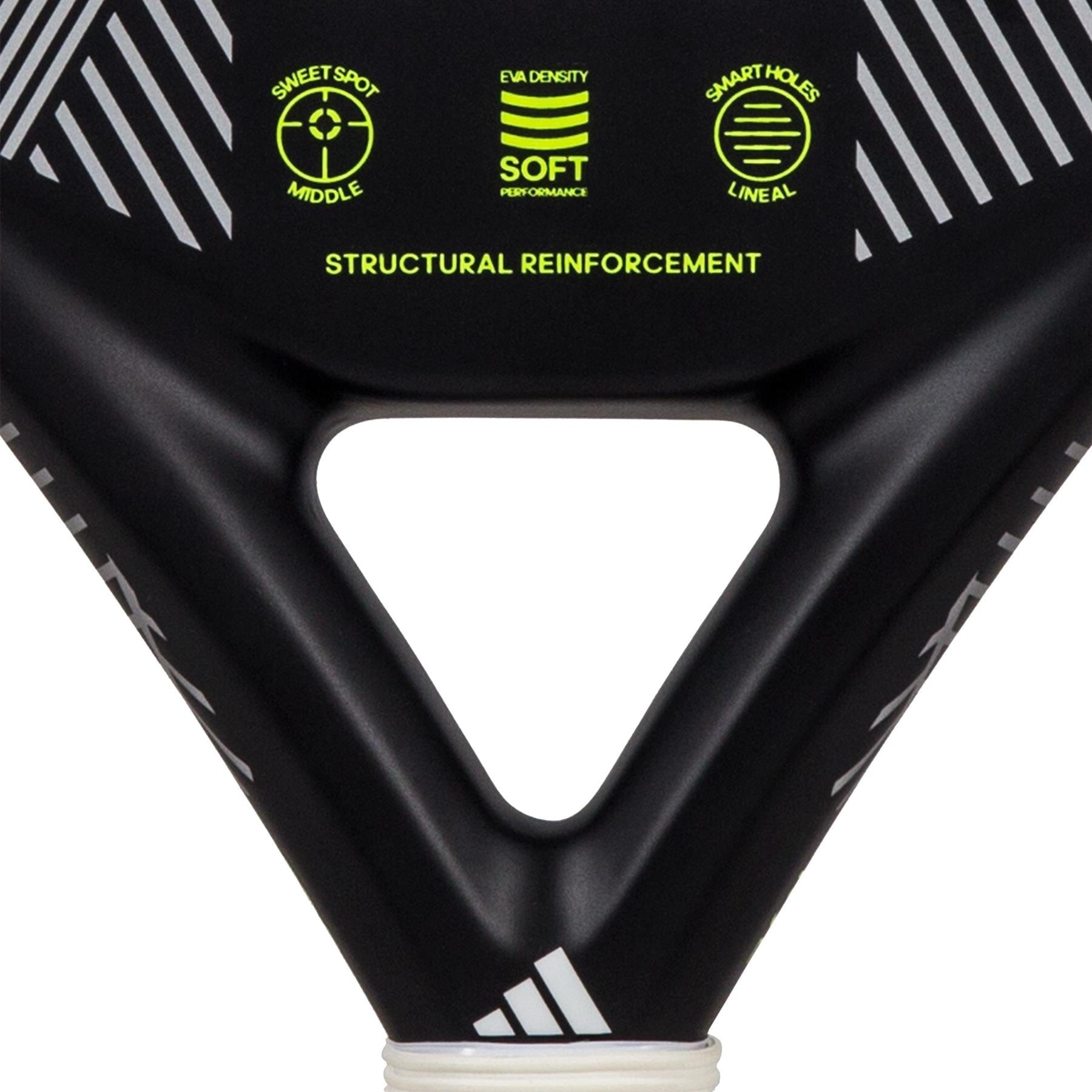 A close-up of the ADIDAS Match 3.3 Padel Racket in black and lime showcases its teardrop-shaped head with neon yellow text and symbols. It highlights features such as "soft performance," "structural reinforcement," "sweet spot middle," and "smart holes lineal," enhanced by a triangle-shaped cutout, making it ideal for beginner players.