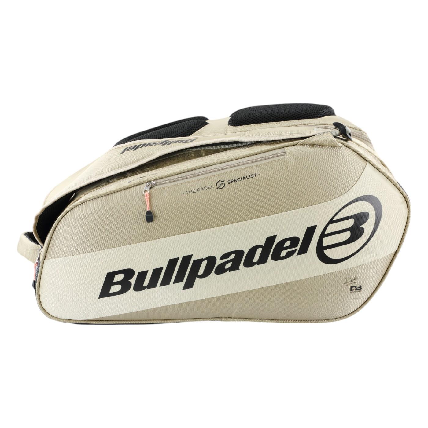 The Bullpadel Vertex 25 Padel Racket Bag in stone features reinforced thermo-lined compartments for your padel racket. It includes multiple sections, a sturdy handle, and a zippered opening, with the brand's logo and text in black. Perfect for carrying sports gear.