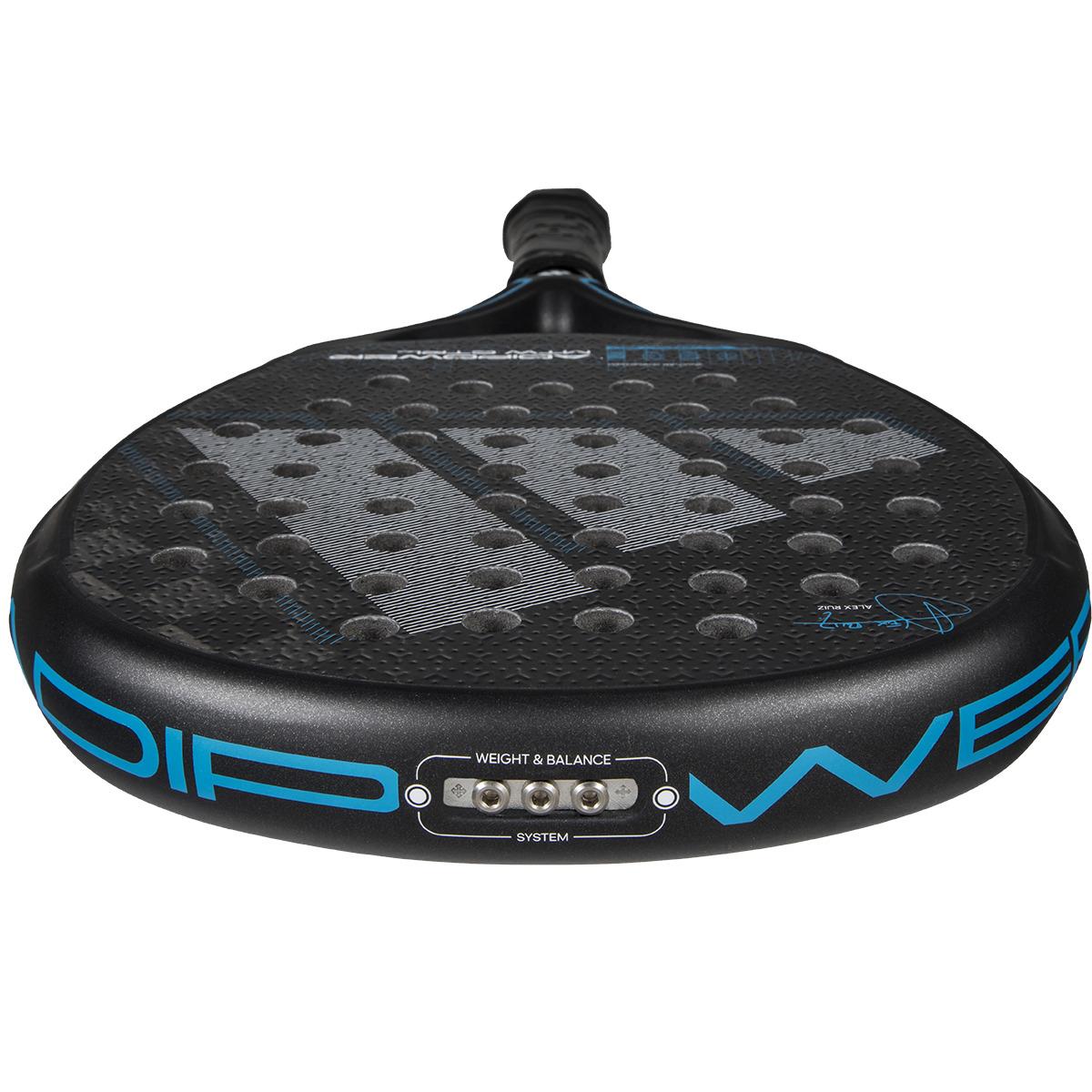 Close-up of the ADIDAS Adipower Multiweight CTRL 3.4 Padel Racket in black and blue, showcasing a textured surface with perforations for aerodynamics. The handle has a black grip, featuring "Weight & Balance System" at the base—ideal for athletes like Álex Ruiz desiring precision and power.