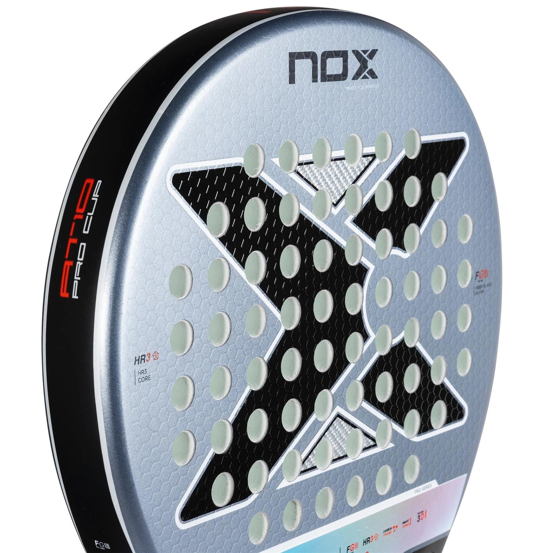 Close-up of the NOX AT10 Pro Cup Comfort By Agustin Tapia 2025 Padel Racket in silver and black, with a bold "X," circular holes, and model name on the rim. The Smartstrap system enables quick wrist strap swapping for safety and comfort.