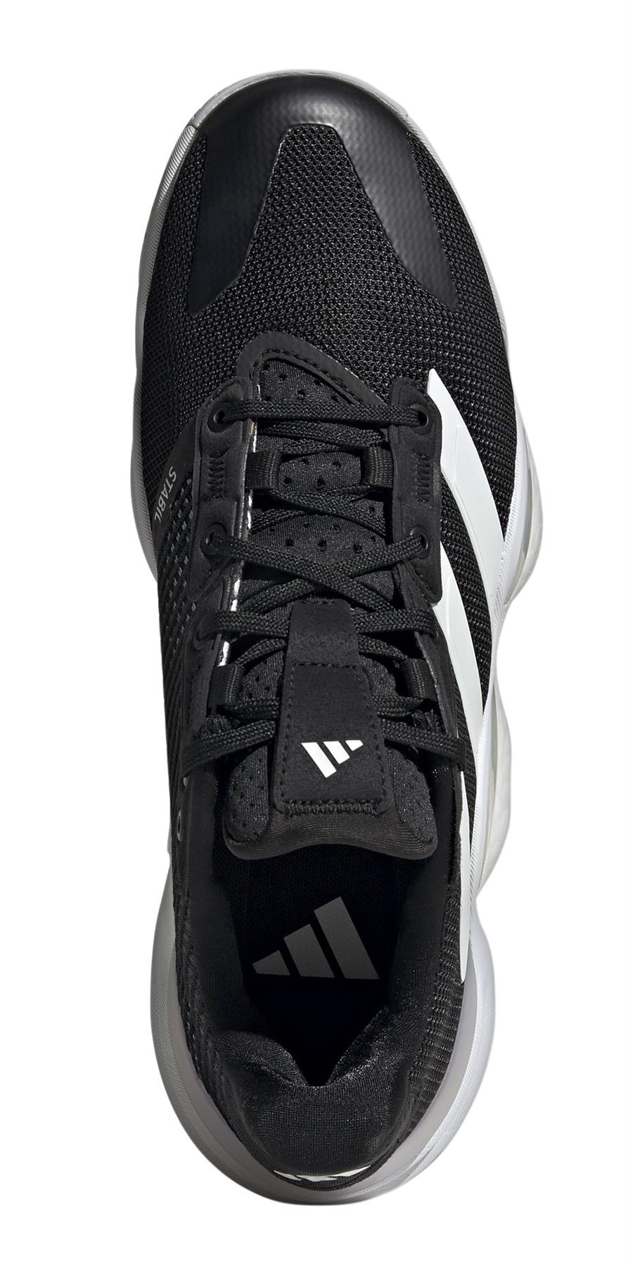 Top view of the adidas Stabil 16 padel shoes, showcasing a black athletic design with white side stripes. These men's shoes have a black mesh upper, black laces, and branded tongue. The BOOST midsole pairs well with the contrasting white sole.