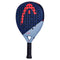 The HEAD Vibe 2025 Padel Racket, in a blue/red design, features a fiberglass hitting surface. It has a distinctive circle and curved lines logo in red and the "Vibe" name on the lower part. The racket's perforated surface complements its wrapped handle for improved play.