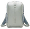 The Kanso Intuko Padel 23L Backpack is a sleek, minimalist design in light gray with blue mesh side pockets and shoulder straps. It features a reflective vertical "kanso" logo and provides a dedicated racket compartment for added functionality.