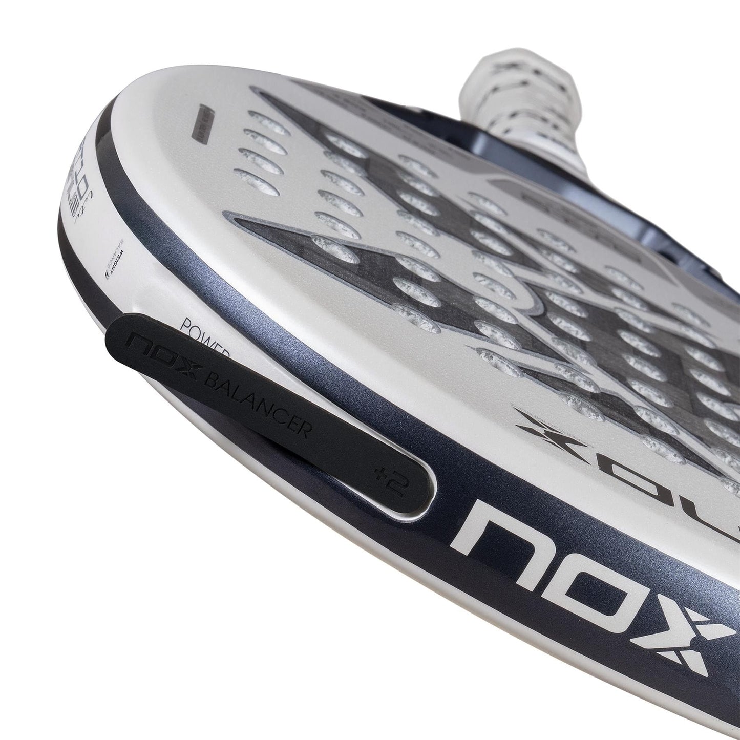 Close-up of the NOX AT10 Genius 12K Alum Extrem Lite By Agustín Tapia 2026 padel racket, showcasing its edge with Weight Balance and a sleek surface with circular holes, reflecting NOX’s advanced design and performance.