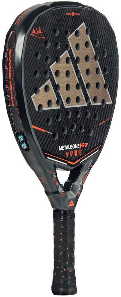 The adidas Metalbone HRD+ by Ale Galán 2026 Padel Racket in black and red features a honeycomb-patterned face, multiple round holes, red and white accents, model name on the side, and a black grip with a subtle adidas logo.