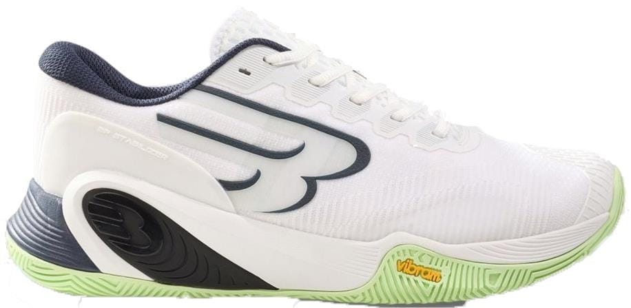 The Bullpadel Hack Vibram 26V Men's Padel Shoes in white feature a black and gray "B" logo, green and white Vibram outsole, dark heel accents, white laces, textured grip for stability, and a dark blue interior lining.