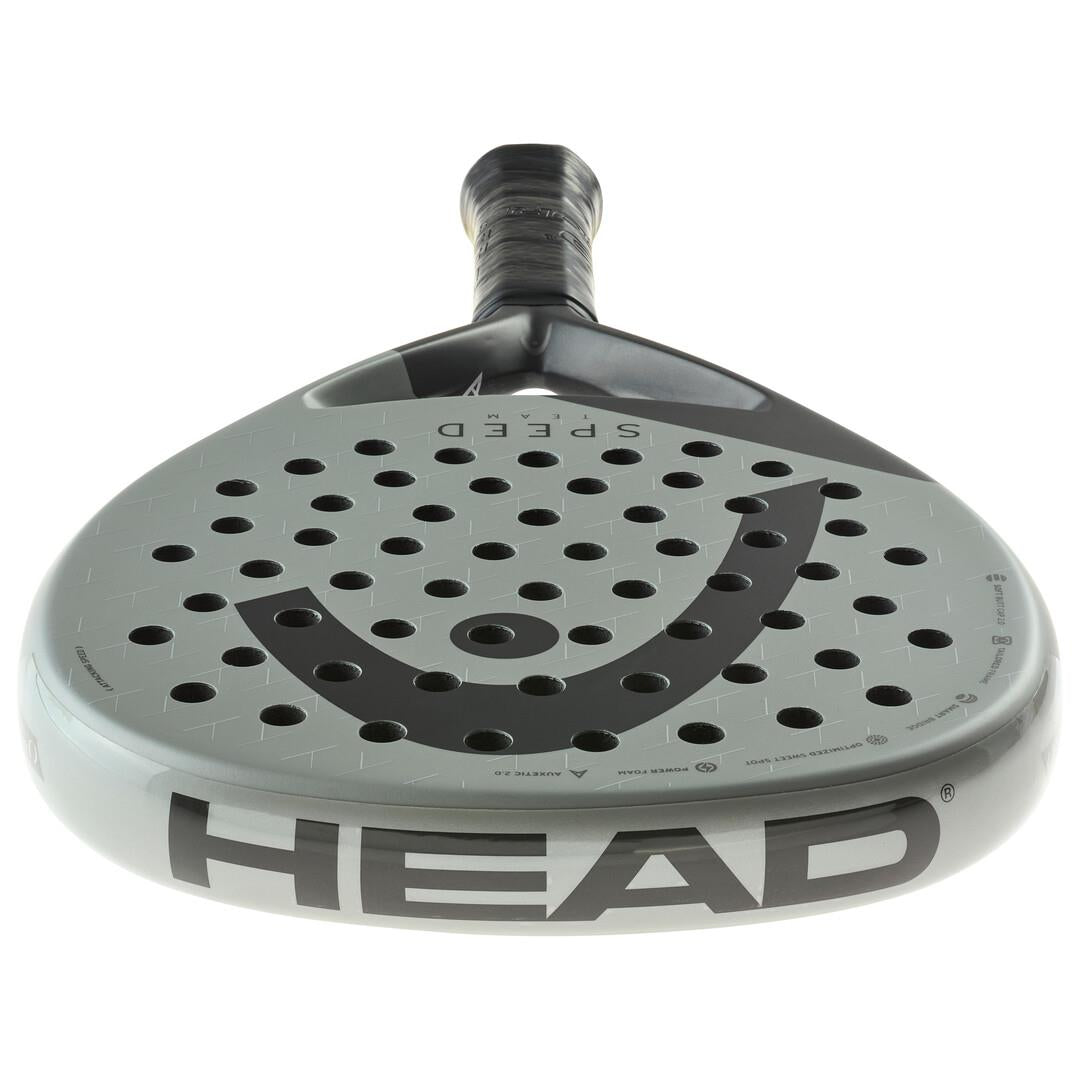 Close-up of the HEAD Speed Team 2025 Padel Racket, featuring a grey surface and black handle, enhanced with Power Foam for optimized play. A black logo and multiple holes adorn the face, while "HEAD SPEED TEAM" is prominently displayed on the side—ideal for cutting-edge performance seekers.