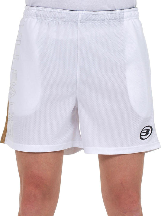 A person wears Bullpadel Campaza Men's Padel Shorts in white, showing a subtle mesh texture. Featuring Quickerdry tech, these Bullpadel shorts display a circular logo on the left leg and faint lettering on the right; only lower torso and upper legs are shown.