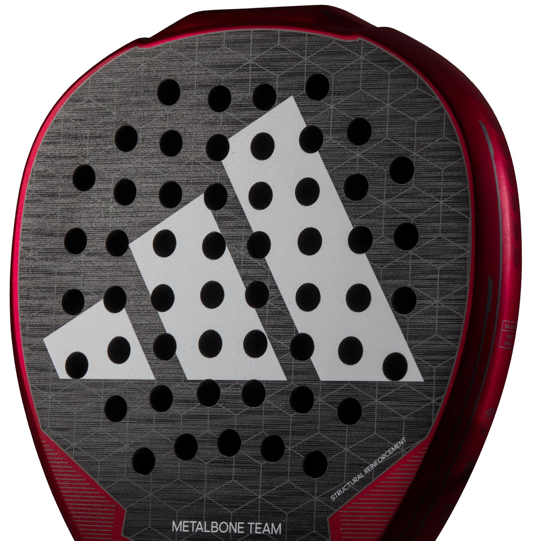 A close-up of the adidas Metalbone Team 3.3 Padel Racket in black highlights its unique diamond-shaped head. The large white logo with three diagonal stripes and Spin Blade Grit enhance its textured surface, accented by round holes and a bold red edge.