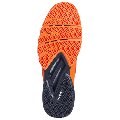 The image features the sole of Babolat Jet Premura 2 Padel Shoes, with vibrant orange textured treads on the front and a black heel pattern. "Vibram" and "midsole" emphasize grip and cushioning, while Matryx technology boosts durability for intense padel matches.
