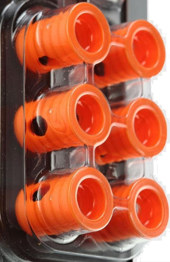 Close-up of six Bullpadel Ease Vibe Padel Dampeners in fluorescent orange, arranged in two rows inside clear packaging—ideal paddle racket accessories from Bullpadel for reducing unwanted racket vibrations.