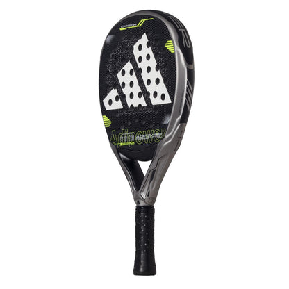 The ADIDAS Adipower Carbon CTRL 3.4 Padel Racket in black and grey boasts a textured surface with the white adidas logo and features Spin Blade Mold technology. It has "Adipower" in green, a black handle, and a wrapped grip for precision play.