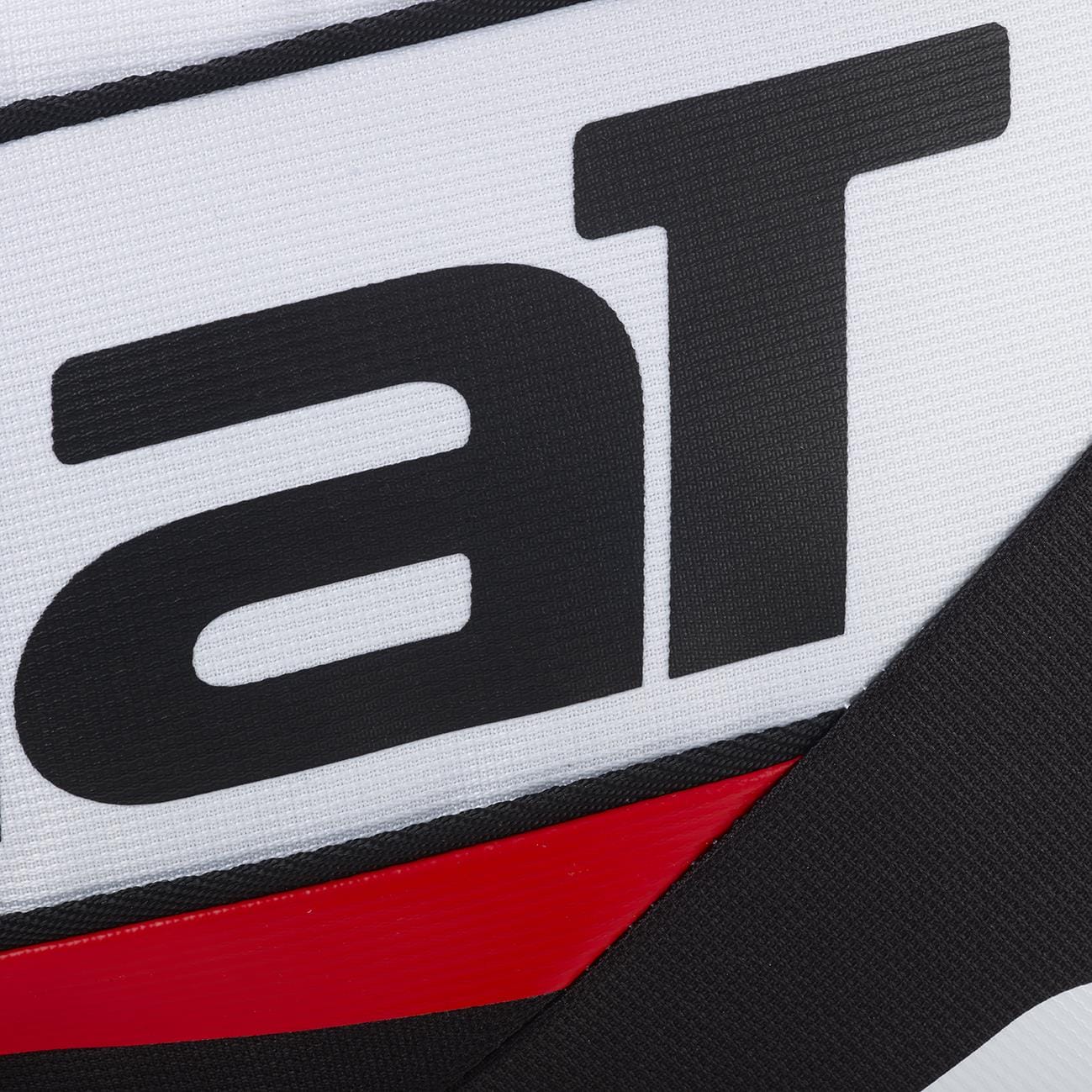 Close-up of the Babolat RH Pro Technical Padel Racket Bag (White/Black/Red) shows its ribbed white surface with bold black "aT" lettering and diagonal black and red lines, reflecting Babolat's premium padel accessories design.