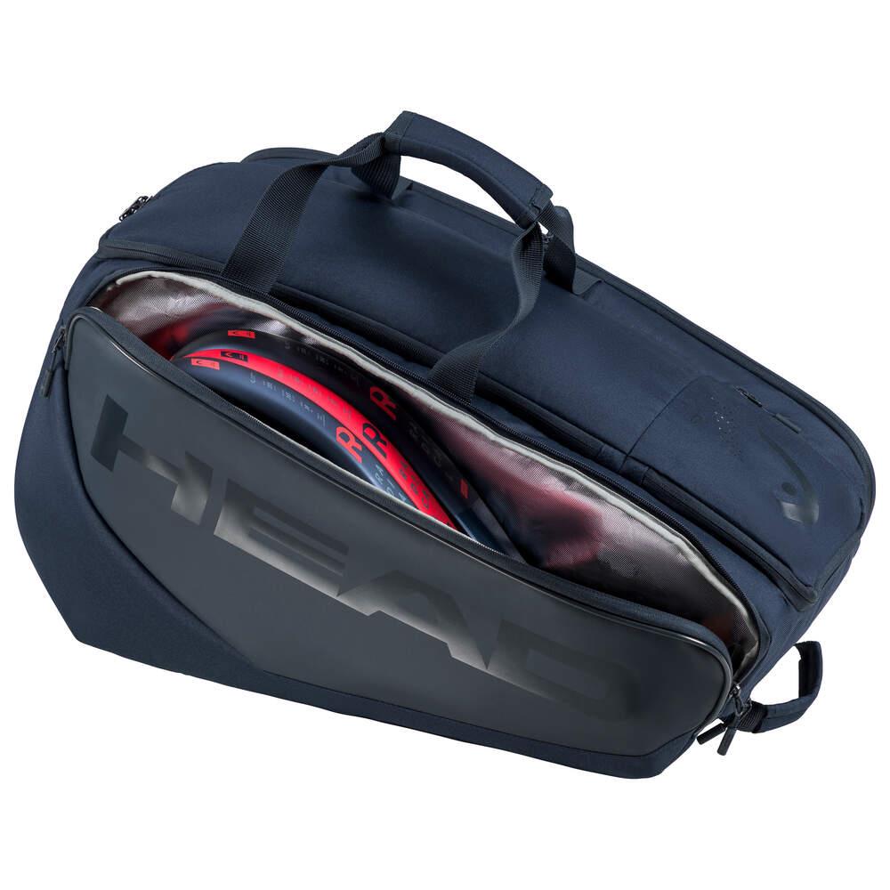 A navy sports bag showcases a partially open zippered compartment, revealing tennis racquets inside. With two handles and "HEAD" prominently displayed on the side, this HEAD Pro Padel Bag L - Navy includes CCT+ climate control technology to protect your gear.