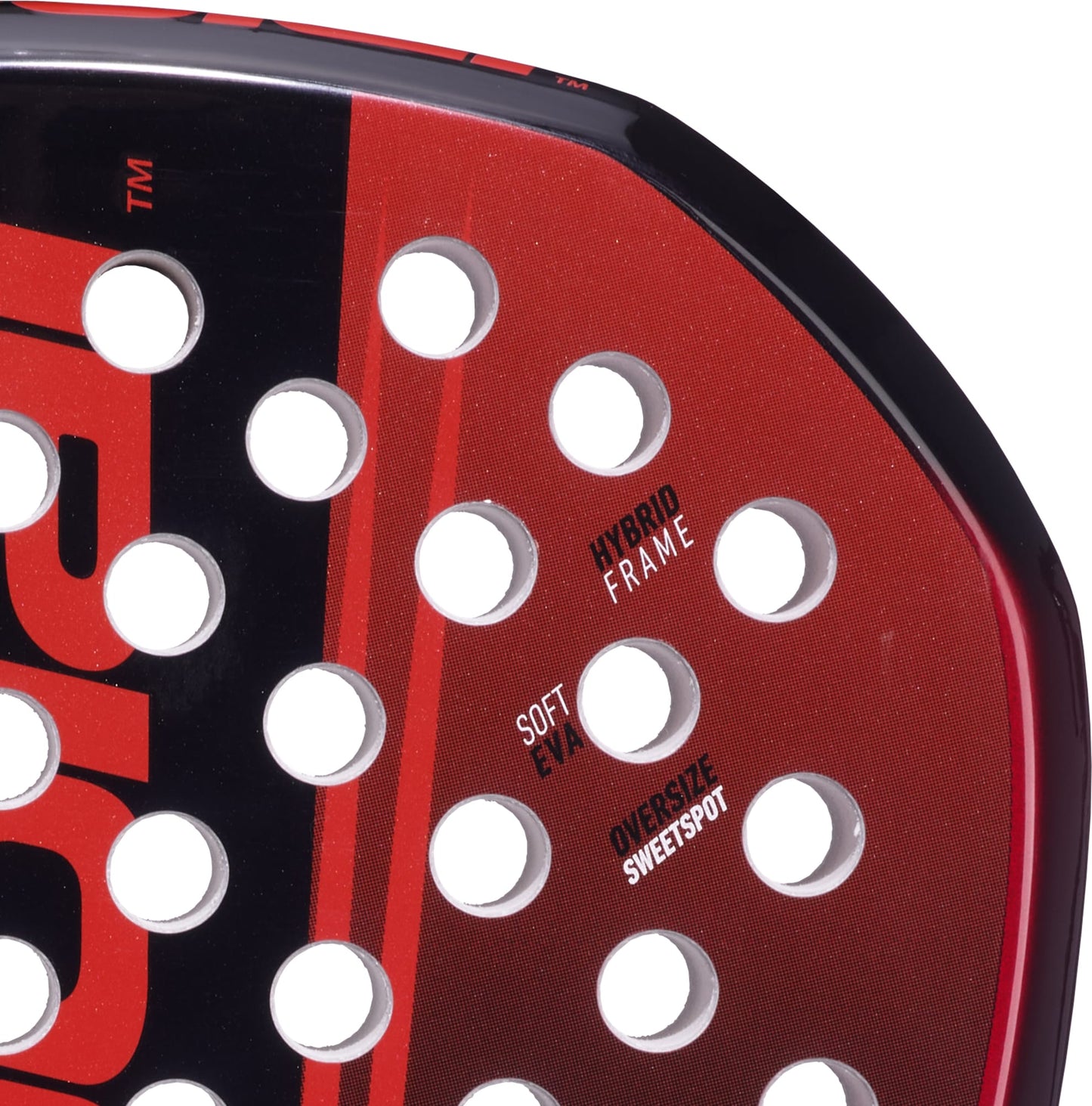 Close-up of the Babolat Technical Origin + 2026 Padel Racket in red and black, highlighting drilled holes and surface text labels including "HYBRID FRAME," "SOFT EVA," and "OVERSIZE SWEETSPOT." This Babolat padel racket is crafted with advanced fibreglass construction for superior performance.
