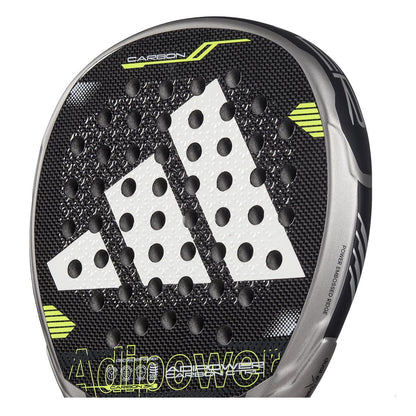 Close-up of an adidas ADIDAS Adipower Carbon CTRL 3.4 padel racket with Spin Blade Mold tech. A large white logo graces the face, with a perforated design for airflow. "Adipower" and "Carbon" stand out against green and silver edge accents on the black/grey finish.