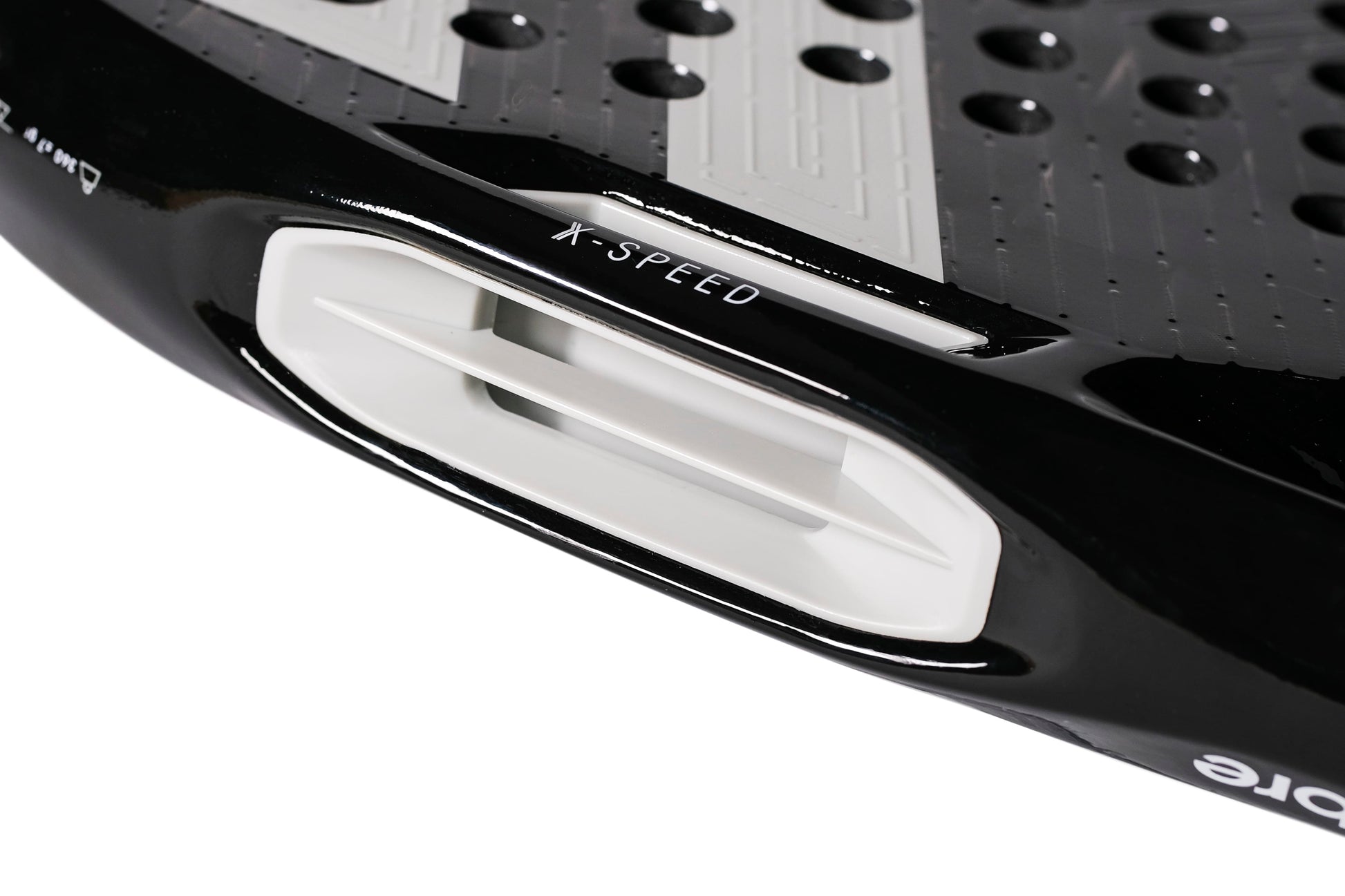 Close-up of the Tecnifibre Curva Power 2026 Padel Racket by Tecnifibre in black, highlighting a white ventilation slot marked “X-SPEED,” a textured 18K carbon surface with circular holes, and a glossy finish.