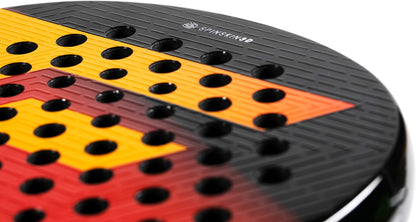Close-up of the Tecnifibre Curva Speed 2026 Padel Racket by Tecnifibre, a black padel racket with red and yellow geometric accents, a textured surface, and circular holes designed for enhanced control and fast hand movement. The “SPINSKIN 360” text is visible near the top edge.