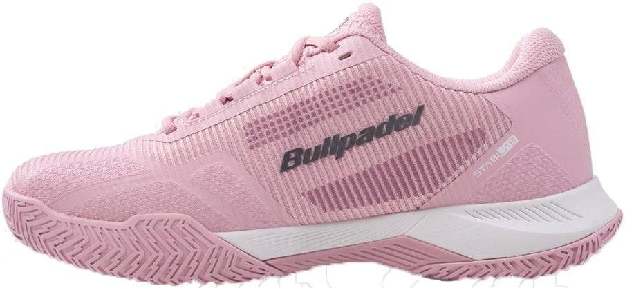 The Bullpadel Performance Comfort 26V Women's Padel Shoes in pink offer a textured sole, lace-up design, subtle stripes, and "Bullpadel" branding on the side, plus a stable fit with a white midsole and gray accents.