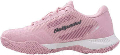 The Bullpadel Performance Comfort 26V Women's Padel Shoes in pink offer a textured sole, lace-up design, subtle stripes, and "Bullpadel" branding on the side, plus a stable fit with a white midsole and gray accents.