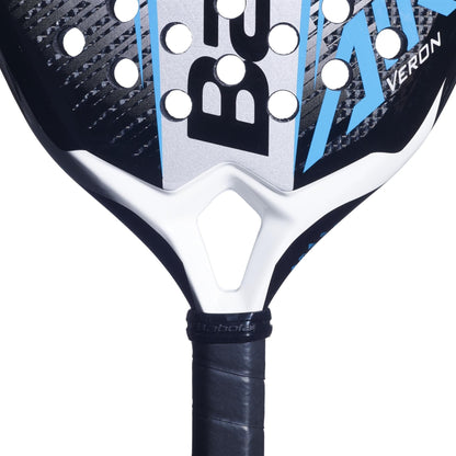 Close-up of the Babolat Air Veron 2.6 Padel Racket by Babolat, featuring a lightweight frame, blue accents, circular holes, black grip tape, and CarbonFlex technology for enhanced performance. “Babolat” and “Veron” logos are partially visible.