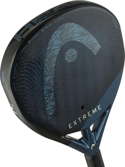 Close-up of the HEAD Extreme One X 2025 Padel Racket by HEAD, showcasing its black and blue design, "EXTREME" print, textured logo, and durable 12K Carbon Fibre construction for enhanced performance.