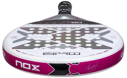 A close-up of the NOX ML10 Pro Cup Silver By Miguel Lamperti 2025 Padel Racket, featuring a pink, black, and white design with a large X pattern, circular holes, signature on the side, and durable carbon structure.