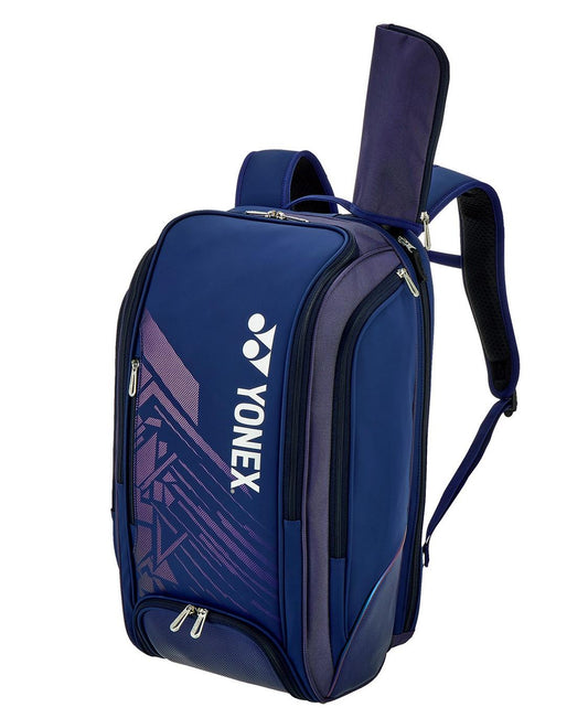 The Yonex 02512EX Expert Padel Backpack in navy blue is perfect for tournaments, featuring a sleek design with two compartments, main zippered section, side zippers, padded shoulder straps, and a handle slot for easy access.