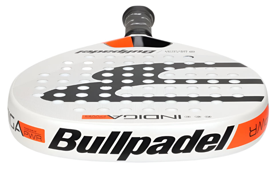 Presenting the Bullpadel Indiga Pwr 2025 Padel Racket - White, an ultralight racket with a diamond-shaped head, white surface, black branding, and orange accents. It boasts a strategic hole pattern and textured grip handle for exceptional performance.