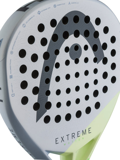 Close-up of the HEAD Extreme Motion 2026 Padel Racket, featuring a white face with black holes and a prominent gray HEAD logo. Its bottom edge showcases a striking neon yellow-green accent, while “EXTREME” is printed near the base. Ideal for advanced padel players, this racket combines power and outstanding performance on the court.
