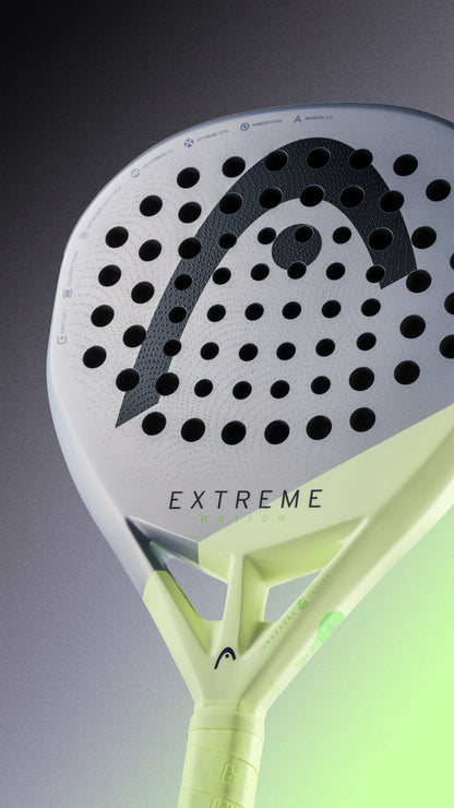 Close-up of the HEAD Extreme Motion 2026 Padel Racket, designed for advanced players, featuring a white and neon yellow color scheme with a perforated surface and glowing green accents on the lower right side.