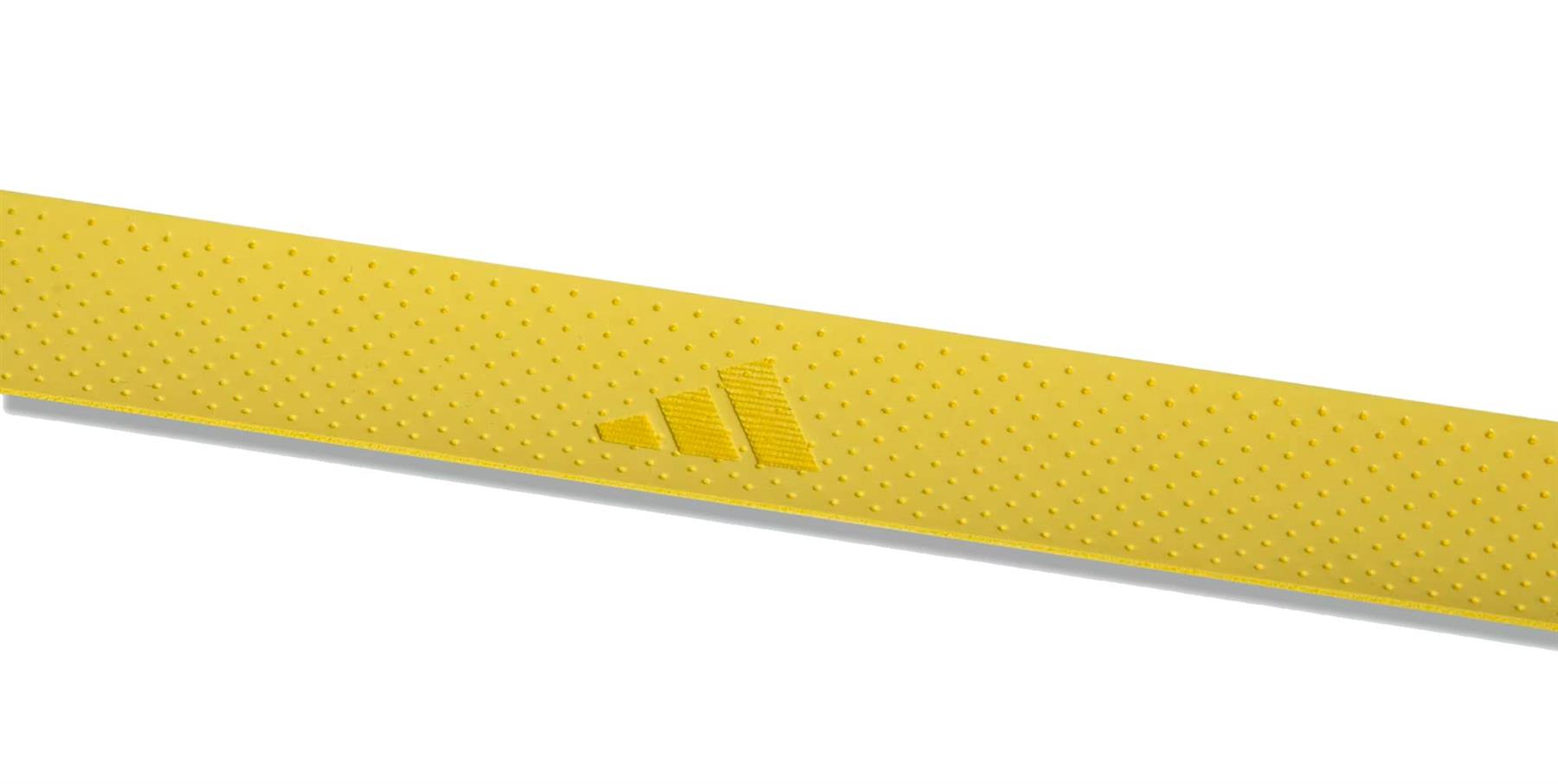 A close-up of a yellow textured strip from the adidas Padel Overgrips (3 Pack) - Yellow, featuring the adidas logo embossed in the center for added comfort and performance against a white background.