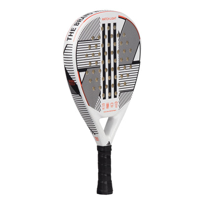 The adidas Match Light 3.3 Padel Racket - White is an ideal choice for beginner players, featuring a lightweight design. It showcases a black and white aesthetic with geometric patterns and red accents, along with the adidas brand name on the frame. The handle is elegantly wrapped in sleek black grip tape.