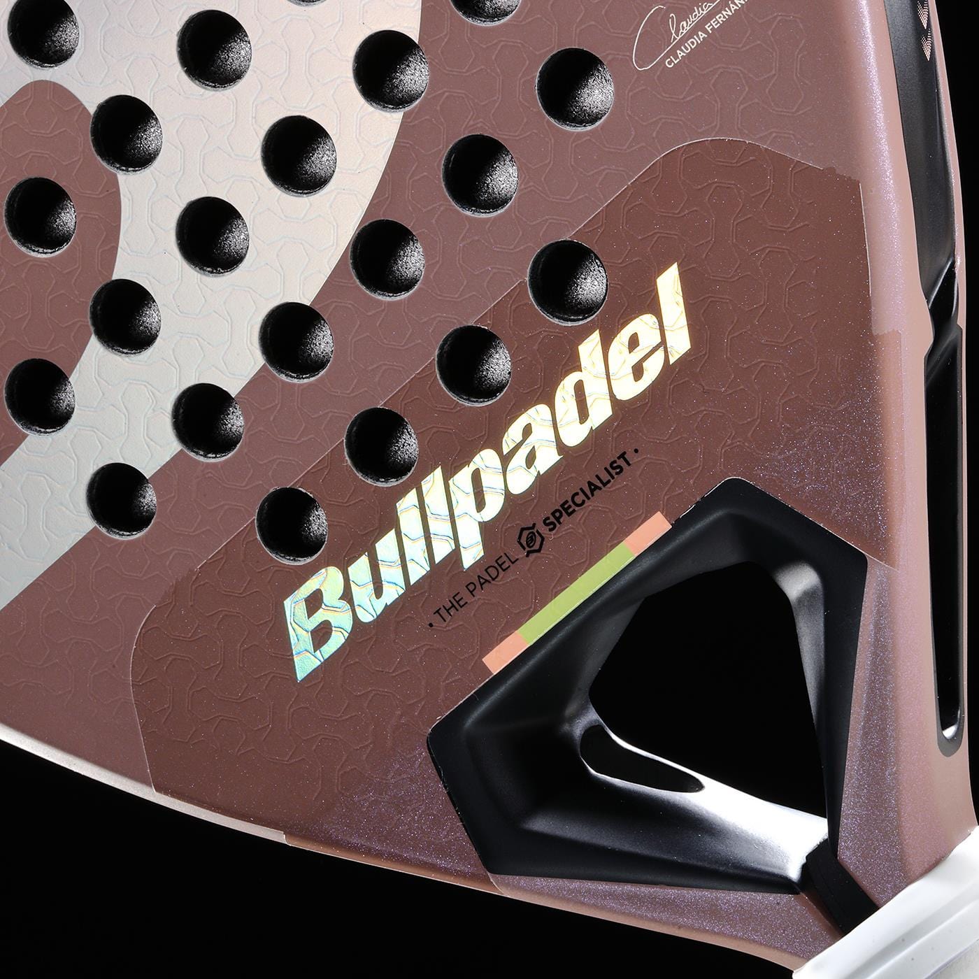 Close-up of the Bullpadel Wonder 2026 Padel Racket - Rose Gold, a professional Bullpadel racket with Hyper Core technology. Its textured rose gold surface, black holes, shiny logo text, and detailed handle base stand out.