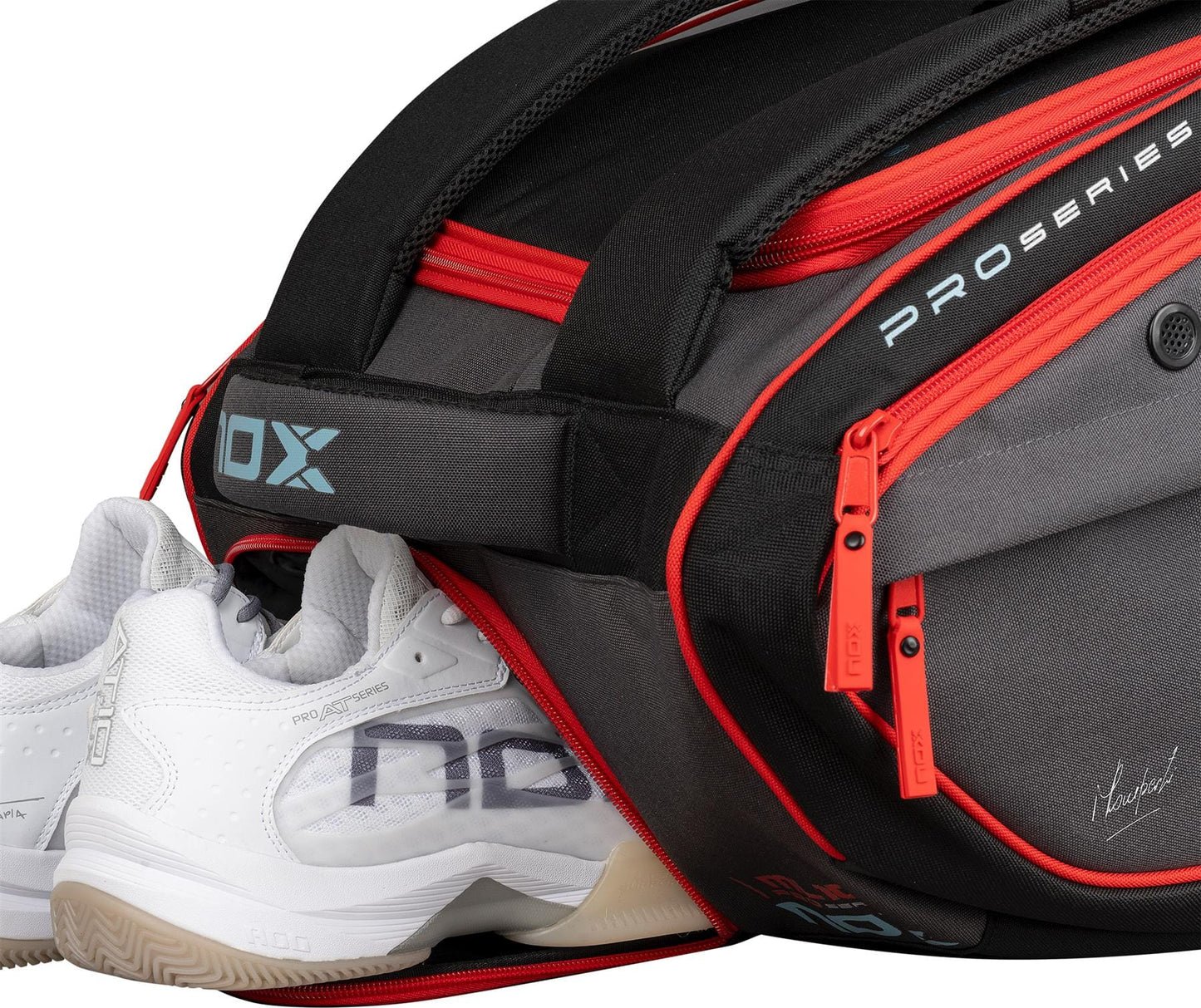 A pair of white sports shoes is partly inside the NOX ML10 Competition XL Compact Padel Racket Bag – Black/Red, which features red zippers, a side pocket with "PRO SERIES" text, and a dedicated shoe compartment.
