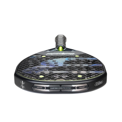 The Bullpadel XPLO 2026 Padel Racket in black features a carbon fiber pattern, blue accents, and a textured surface. Shown from the handle end, it highlights Bullpadel branding and its powerful performance design.