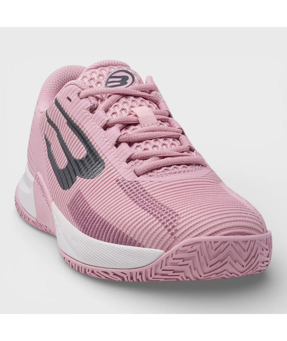 The Bullpadel Performance Comfort 26V Women's Padel Shoes in pink feature a textured sole for stability, breathable mesh upper, large dark gray side logo, pink laces, and a white accent near the sole for sporty style.