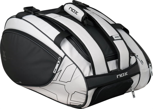 The NOX Luxury Master Series 3 Racket Padel Bag in black and white features multiple zippered compartments, sturdy handles, and shoulder straps, perfect for carrying your gear like the pros.