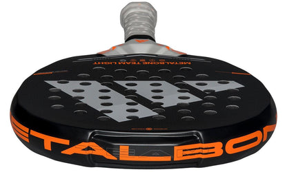 A close-up of the adidas Metalbone Team Light 2026 Padel Racket in black, designed for advanced players, with bold "METALBONE" lettering, circular surface holes, and a wrapped handle.